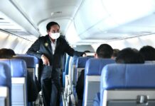 Opinion: Is Gen. Prayut an “Experienced Pilot” Who Has Been Flying Air Thailand for the Past 8 Years? A file photo of PM Prayut Chan-o-cha talking to passengers on an airplane.