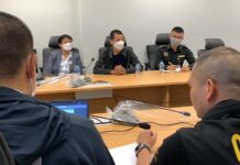 Hacker “9Near” Surrenders to Police Sgt. Maj. Khemarat Boonchuay, center, accompanied by a military officer at the Cyber Crime Investigation Bureau on Apr. 12, 2023.