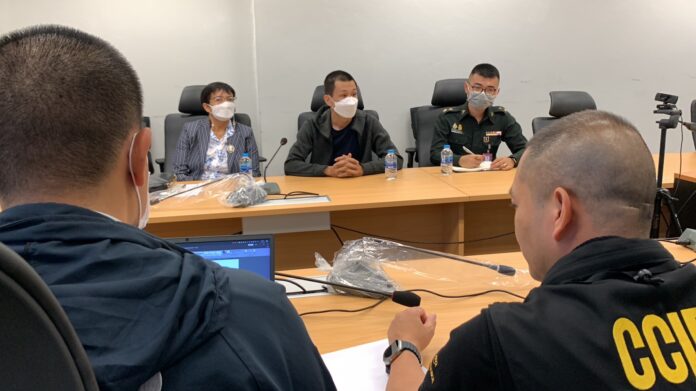 Sgt. Maj. Khemarat Boonchuay, center, accompanied by a military officer at the Cyber Crime Investigation Bureau on Apr. 12, 2023.