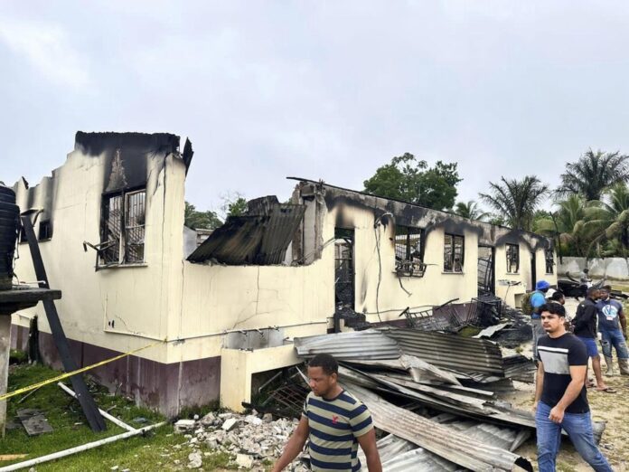 In this photo provided by Guyana's Department of Public Information, the dormitory of a secondary school is burned in Mahdia, Guyana, Monday, May 22, 2023. Photo: Guyana's Department of Public Information via AP Photo
