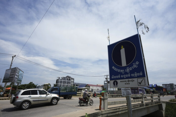 Political party Candlelight Party's poster, right, is displayed near a bridge outside Phnom Penh, Cambodia, Thursday, May 25, 2023. Photo: Heng Sinith / AP