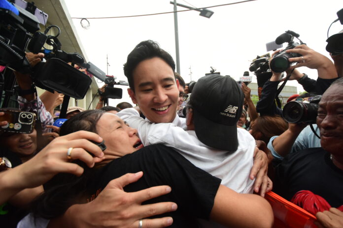 Supporters hug Move Forward Party PM candidate Pita Limjaroenrat before he enters the parliament on Jul. 4, 2023.