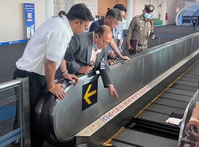 Officials inspect the moving walkway at Don Mueang International Airport on Jun. 29, 2023.