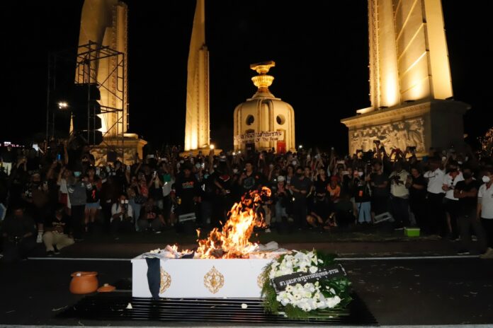 Protesters burn a symbolic coffin during a protest against the Constitutional Court's decision to suspend Move Forward Party leader Pita Limjaroenrat from his MP duties pending its ruling on whether he violated election law at the Democracy Monument on July 19, 2023. Protesters burn a symbolic coffin during a protest against the Constitutional Court's decision to suspend Move Forward Party leader Pita Limjaroenrat from his MP duties pending its ruling on whether he violated election law at the Democracy Monument on July 19, 2023.