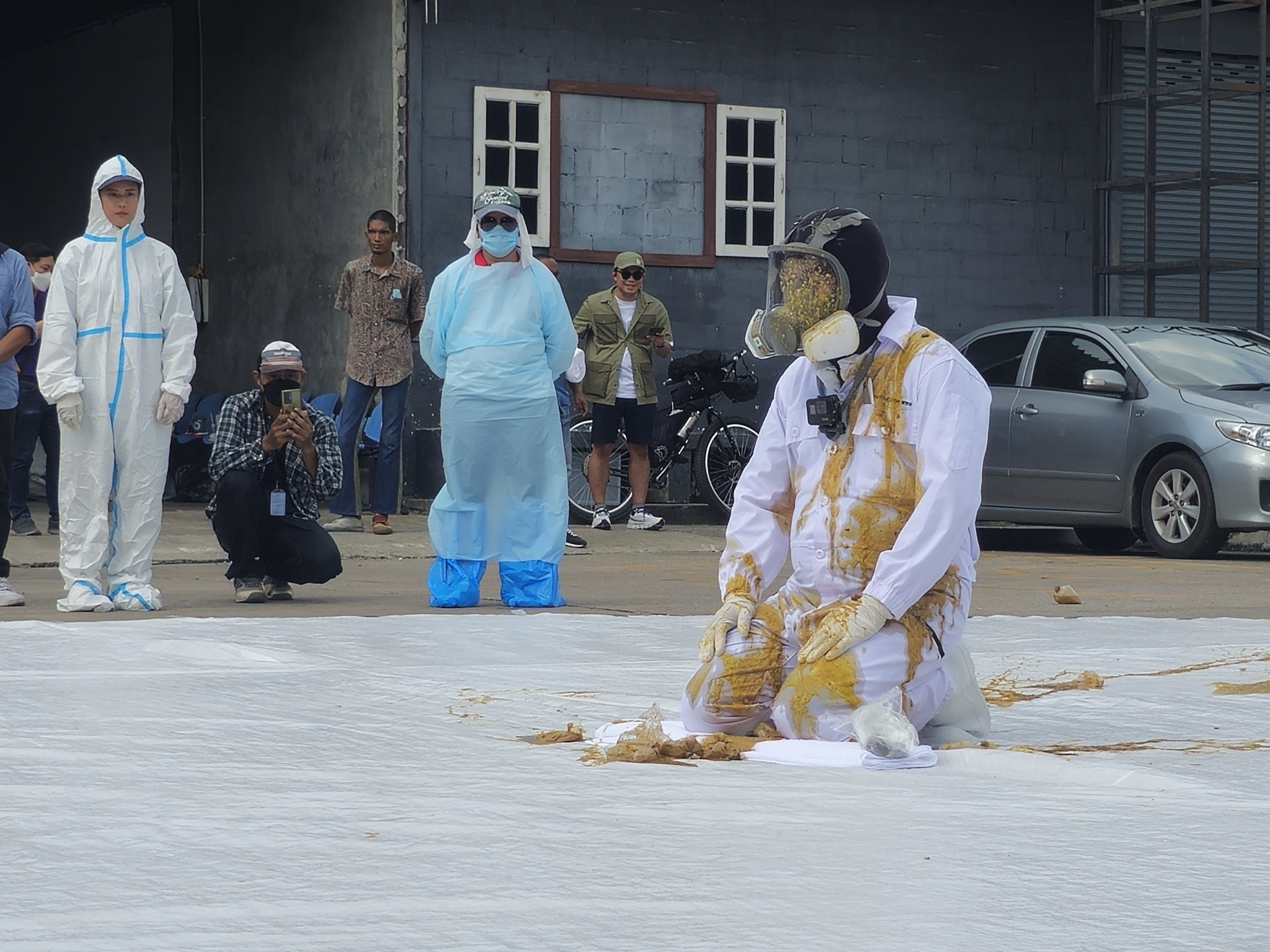 Duangrit Bunnag, a key promoter of the ruling Pheu Thai Party, sits as he is being thrown with feces to honor his pledge to protest against Pheu Thai party's coalition with pro-junta parties at Mirror Art Gallery in Bangkok on Aug. 2, 2023. Duangrit Bunnag, a key promoter of the ruling Pheu Thai Party