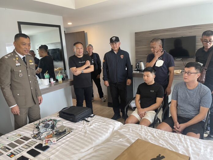 Police in Pattaya City arrest Chinese national Zhang Qiyu and Taiwanese national Chiu Yung Sheng at a hotel room on Sept. 28, 2023.
