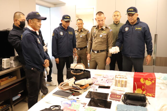Police inspect cash and luxury items seized from a cryptocurrency scam network in a hotel in Rama IX area. Police inspect cash and luxury items seized from a cryptocurrency scam network in a hotel in Rama IX area.