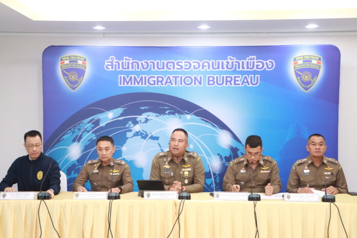 Deputy immigration commander Phanthana Nuchanart, center, speaks during a briefing at the Immigration Bureau headquarters in Bangkok on Nov. 23, 2023.