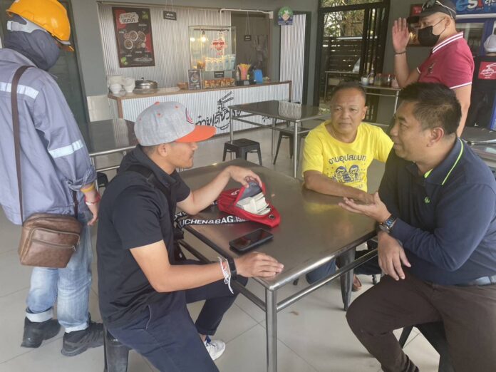 Plainclothes police officers arrest two suspects who attempt to sell counterfeit U.S. dollar banknotes at a gas station in Buriram province on Jan. 17, 2024.