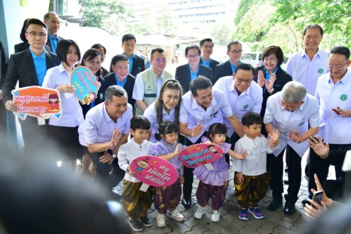 Health minister Cholanan Srikaew and public health officials pose with children at an event to boost the birth rate on Nov. 15, 2023.