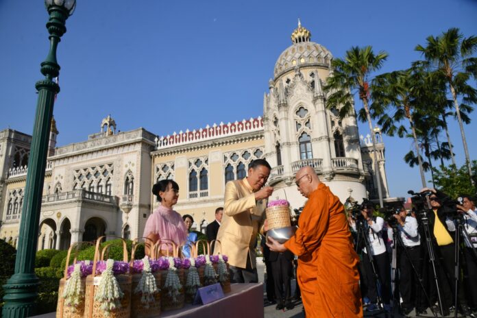 PM Srettha Thavisin and his wife give alms to a monk on the occasion of New Year's Day at the Government House in Bangkok on Jan. 2, 2024.