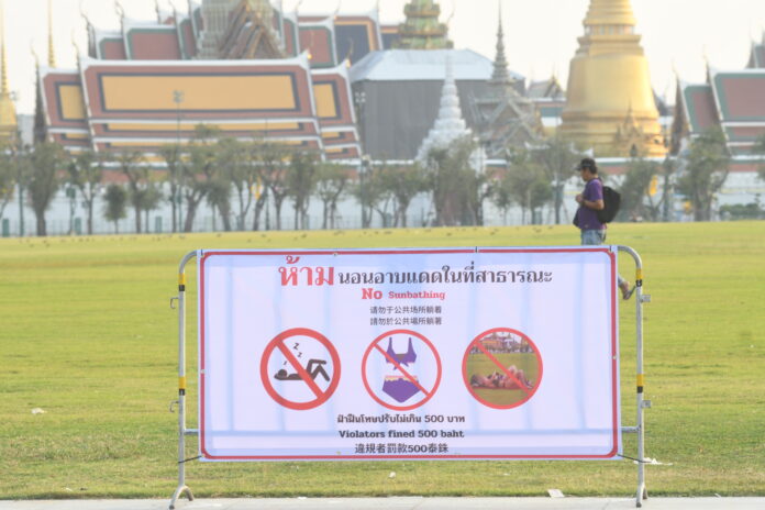 A sign posted at Sanam Luang in Bangkok prohibiting sunbathing on the lawn taken on Jan. 18, 2024.