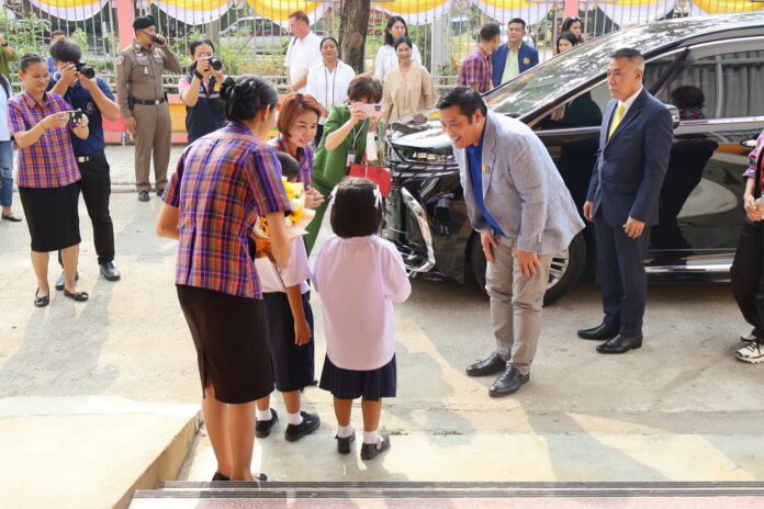 Vacharaesorn Vivacharawongse greets students during a visit to Kanchanaburi Provincial Deaf School in Kanchanaburi province on March 12, 2024.