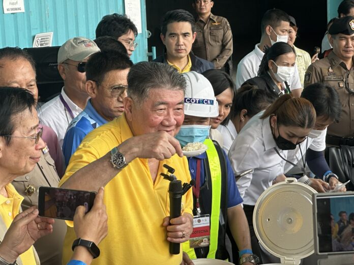 Deputy PM and Commerce Minister Phumtham Wechayachai shows a scoop of cooked 10-year-old rice during an inspection of a warehouse in Surin province, where the stock of rice originally brought in as part of PM Yingluck Shinawatra's controversial rice price mortgage program are kept, on May 6, 2024.