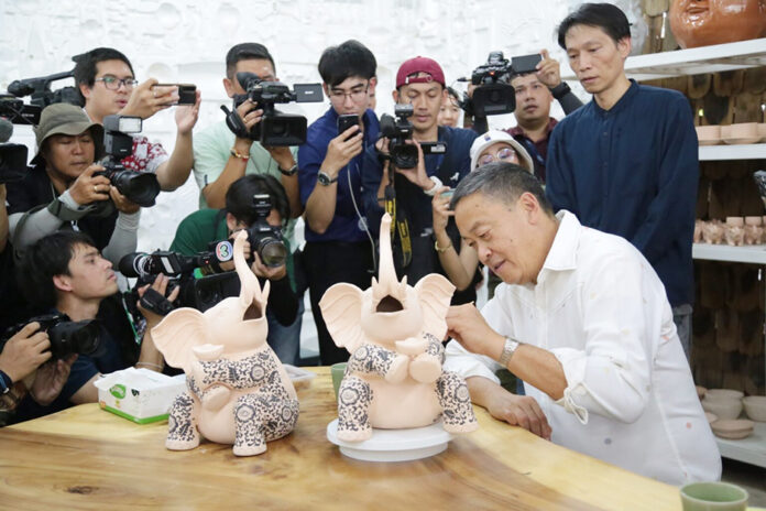 srettha ceramic PM Srettha Thavisin paints an elephant ceramic figurine during a visit to a ceramic factory in Lamphun province on June 8, 2024.