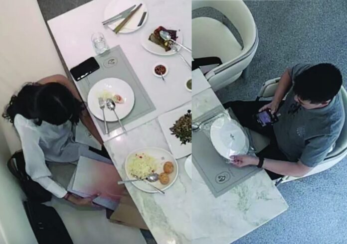 Kaithong2 CCTV footage from one of Kaithong's branches reveals a foreign male customer using his mobile phone to photograph the restaurant's menu, while a female customer takes the restaurant's menu book in her bag, on April 29, 2025.