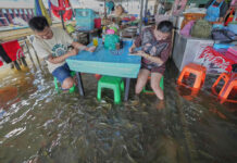 A Flooded Restaurant in Thailand Brings Delight With Swimming Fish Among Diners