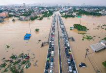 Families in Southern Thailand Perch on Rooftops to Escape Flooding that Has Killed at Least 33