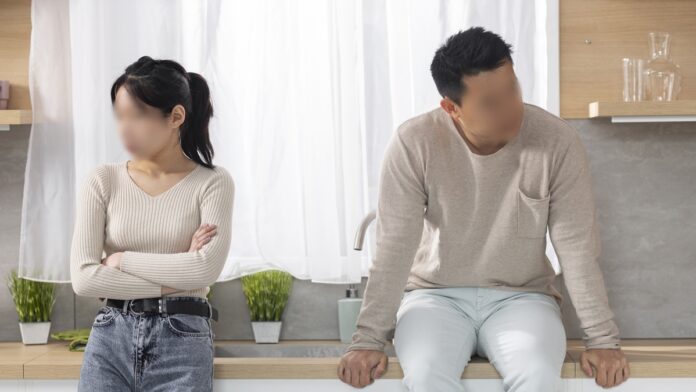 Upset chinese man and woman having quarrel at kitchen