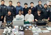 Phuket busts South Korean drug gang, arrests four with export stash Thai officials stand behind the arrested South Korean men with seized evidence laid out on the table ahead of them.