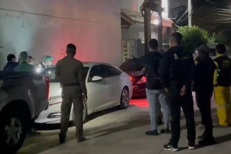 Authorities are seen standing around the car at night shining lights into the windows to try and see inside