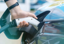 Soaring oil prices drive EV demand surge in Korat a picture of a man holding an EV charger in an EV