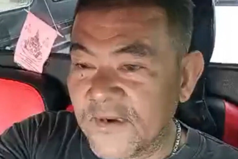 a headshot photograph of the cremation worker wearing a black shirt in what appears to be a car, while he looks forward