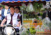 Anutin drives motorcycle grocery cart around Thai Khu Fah Building to promote the Thai Help Thai campaign