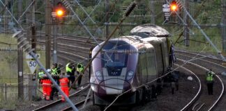Two trains collide north of London, killing at least 1 person and seriously injuring dozens