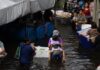 Bang Kapi still flooded as residents stock up, some sleep on skywalk