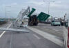 Crane truck hits road sign, blocking three traffic lanes Crane truck hits road sign, blocking three traffic lanes