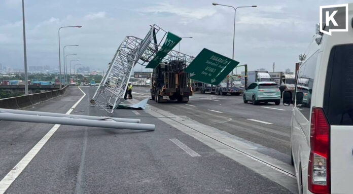 Crane truck hits road sign, blocking three traffic lanes Crane truck hits road sign, blocking three traffic lanes
