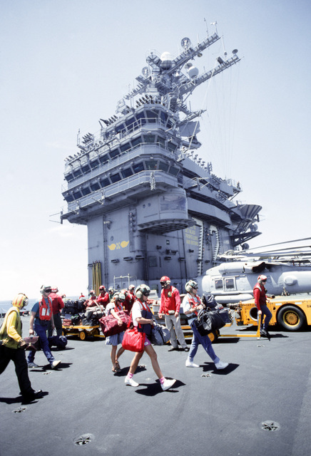 families walk across the flight deck of the nuclear powered aircraft carrier d4f7f4