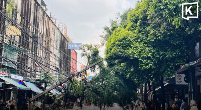 Power pole crashes down as strong winds and heavy rain hit Bangkok