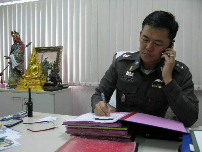 Pol.Col. Jakkapop Sukontaraj, taking phonecall from another police officer during the interview.