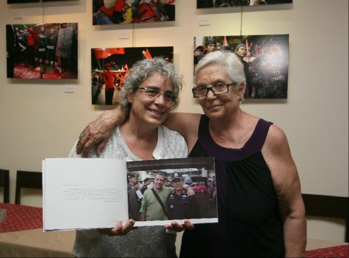 Elizabeth Polenghi, holding collection of Fabio's last pictures in Bangkok, with her mother at FCCT.
