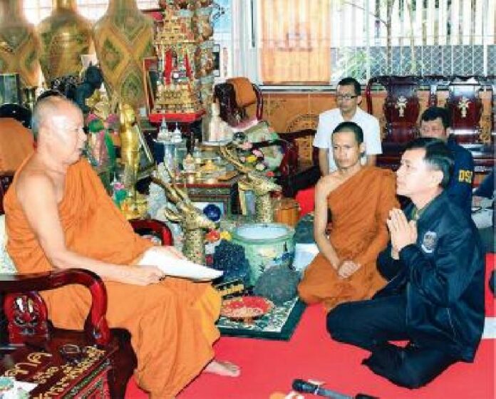 DSI agent receiving order of Nen Kham's defrocking from a senior monk