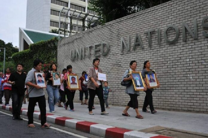 Ms. Payao Akhard (center) leading her group on a march to the Government House in June 2013