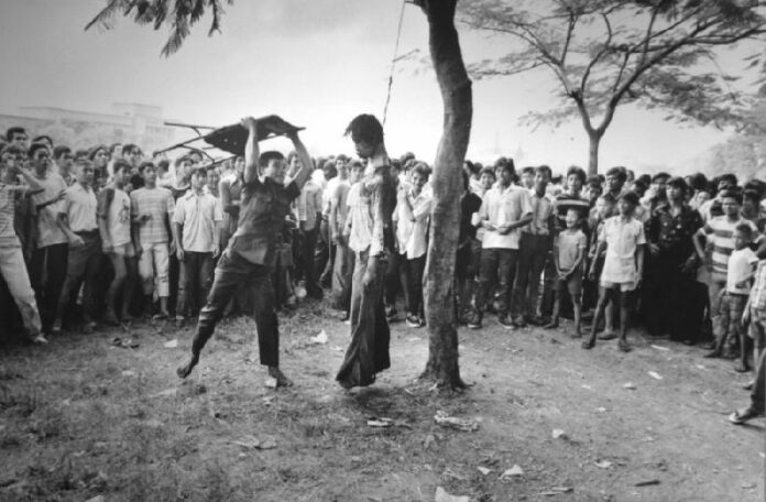The lynching and beating of a student outside Thammasat University which has become the iconic image of October 6 Massacre