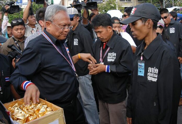 Mr. Suthep Thaugsuban handing out Buddhist amulets to volunteer guards of the anti-government protests, 18 November 2013