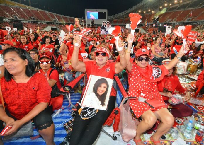 A Redshirt protester holding portrait of Prime Minister Yingluck Shinawatra at Rajamangala Stadium