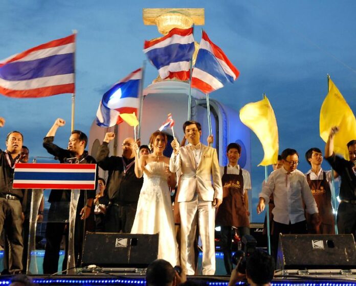 Two anti-government protesters getting married on the stage of the rally at Ratchadamnoen Avenue, 22 November 2013