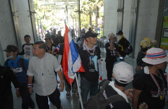 Anti-government protesters breaking into a state TV station, 1 December 2013