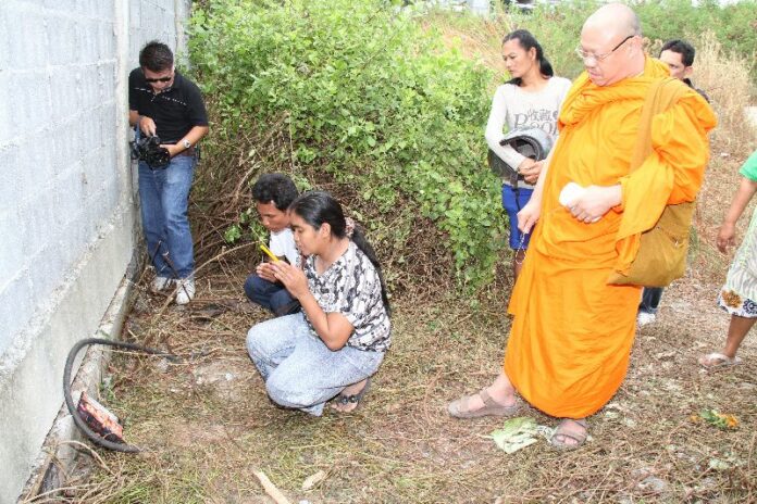 A monk conducting a ceremony to calm the spirit of the 6 year old 'nong Cartoon' at the spot where she is believed to have been raped and murdered, 19 December 2013