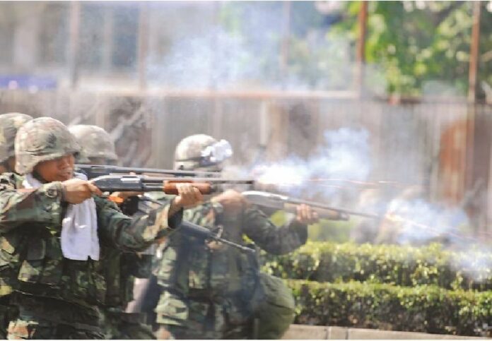 Soldiers firing their weapons at Redshirts protesters in Bangkok, 14 May 2010