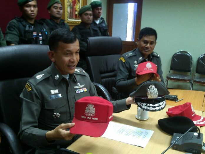 Pol.Maj.Gen. Pattanawuth Angkanawin showing police-issued red caps.