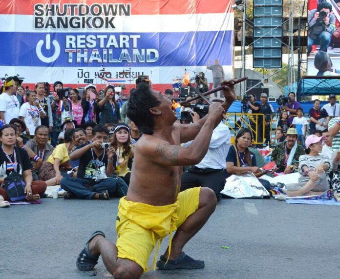 A flame eater performing at protest site in Pathumwan Intersection, 30 January 2014