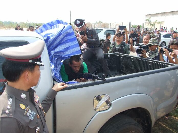 Mr. Manuedang Maesae showed the police during crime scene re-enactment how he allegedly shot UDD leader Kwanchai Praipana, 8 February 2014