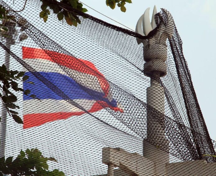 Thai national flag seen from behind anti-grenade net at anti-government rally in Lumpini Park, 11 March 2014