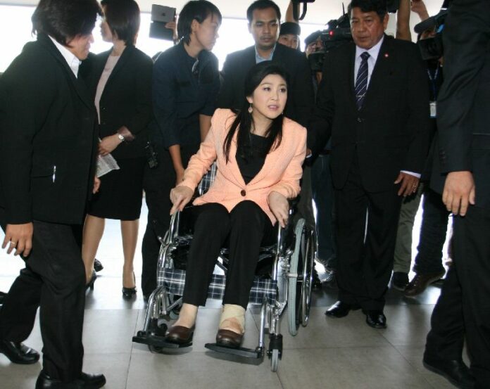 Prime Minister Yingluck Shinawatra is confined to a wheelchair as she attends the Cabinet meeting today; she has slipped and injured herself at a noodle shop in Chiang Mai province on Saturday.